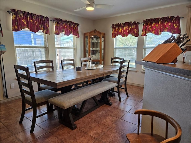 tiled dining area with ceiling fan