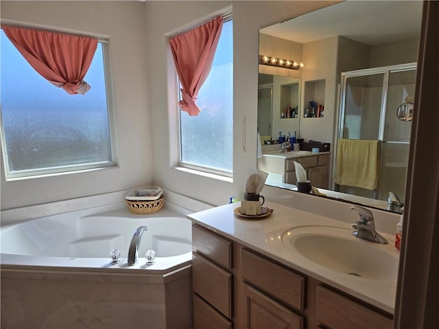 bathroom with shower with separate bathtub and vanity