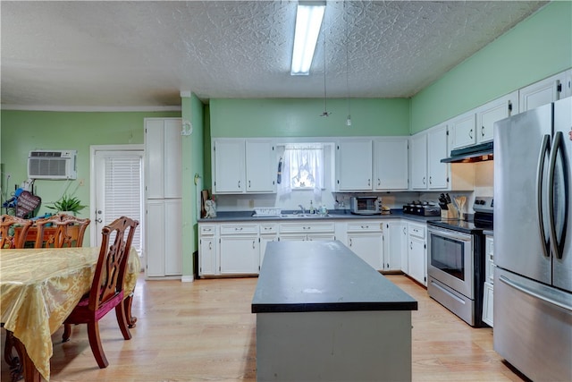 kitchen with white cabinetry, appliances with stainless steel finishes, and light hardwood / wood-style floors