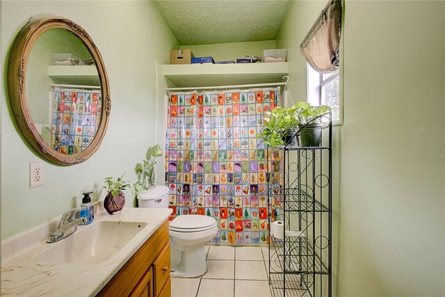 bathroom with toilet, tile patterned flooring, a textured ceiling, vanity, and walk in shower