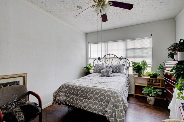 bedroom with dark wood-type flooring, ceiling fan, a textured ceiling, and ornamental molding