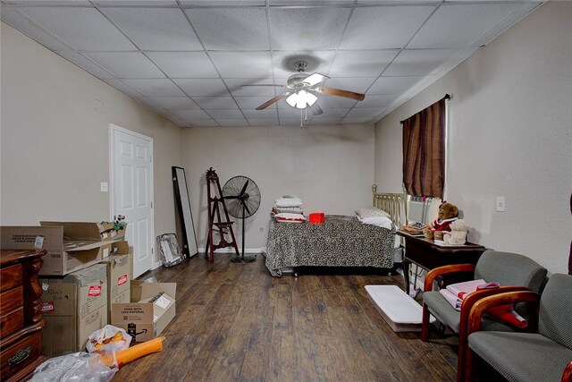 bedroom featuring a paneled ceiling, ceiling fan, and dark hardwood / wood-style floors