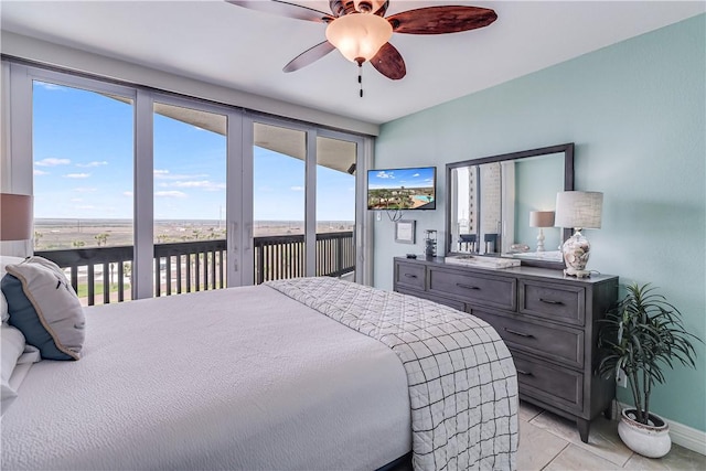 bedroom featuring baseboards, access to exterior, and ceiling fan