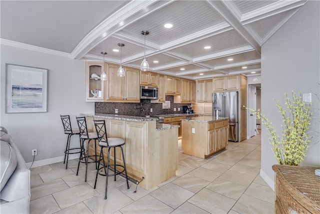 kitchen with backsplash, light stone countertops, light brown cabinetry, appliances with stainless steel finishes, and a peninsula