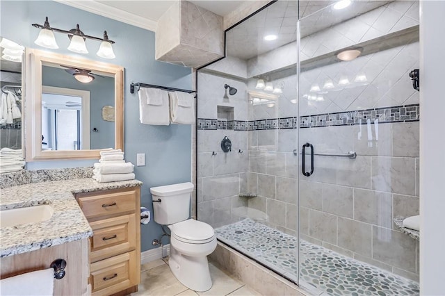 bathroom featuring tile patterned flooring, vanity, toilet, ornamental molding, and a shower stall