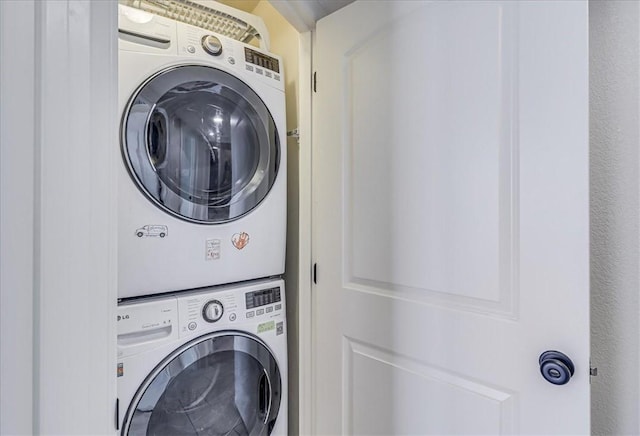 laundry room with stacked washer and clothes dryer and laundry area