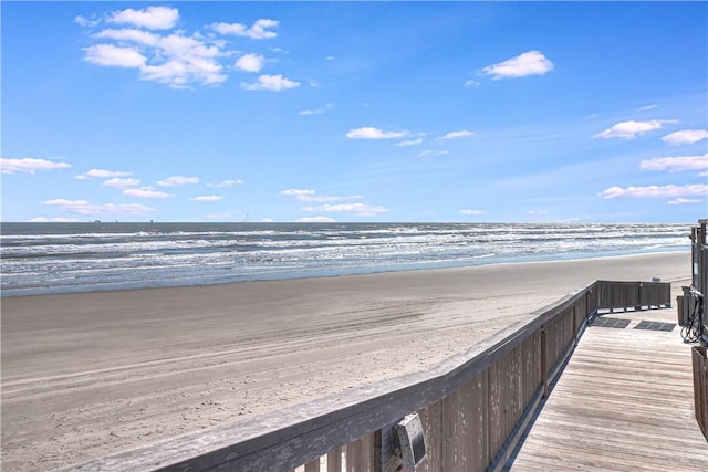 surrounding community featuring a water view and a beach view