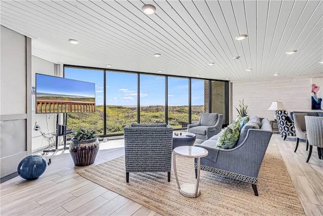 living room featuring floor to ceiling windows, wood ceiling, light wood finished floors, and recessed lighting