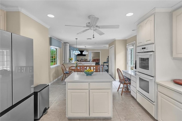 466 Coral, Corpus Christi, TX 78411 - kitchen with freestanding refrigerator, double oven, ceiling fan, a kitchen island, and crown molding