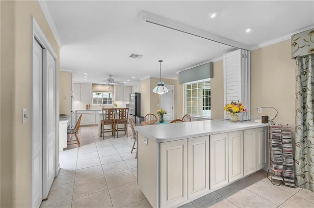 466 Coral, Corpus Christi, TX 78411 - kitchen featuring crown molding, light countertops, light tile patterned flooring, a ceiling fan, and recessed lighting