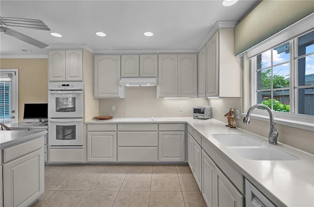 466 Coral, Corpus Christi, TX 78411 - kitchen with white double oven, light countertops, under cabinet range hood, light tile patterned floors, and recessed lighting