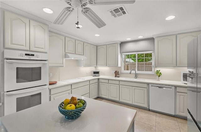 466 Coral, Corpus Christi, TX 78411 - kitchen featuring white appliances, under cabinet range hood, light tile patterned floors, ceiling fan, and light countertops