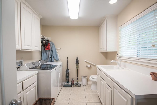466 Coral, Corpus Christi, TX 78411 - laundry room with washer and clothes dryer, light tile patterned floors, and cabinet space