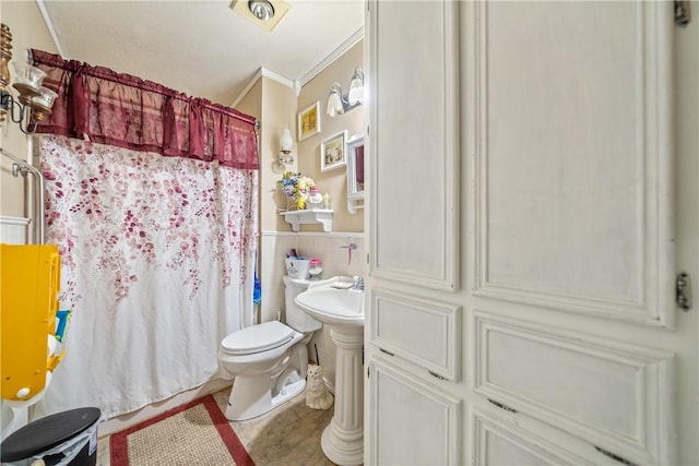 bathroom featuring a shower with curtain, toilet, tile walls, and crown molding