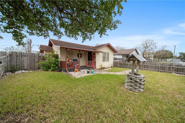 rear view of property with a yard, a patio area, and a wooden deck