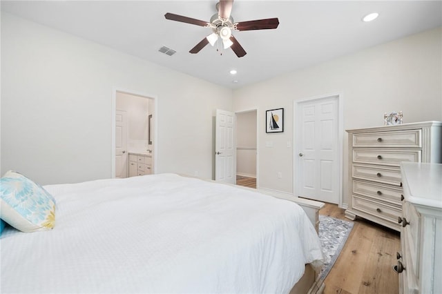 122 Lavaca Cir, Rockport, TX 78382 - bedroom featuring light wood finished floors, ensuite bathroom, visible vents, recessed lighting, and a ceiling fan