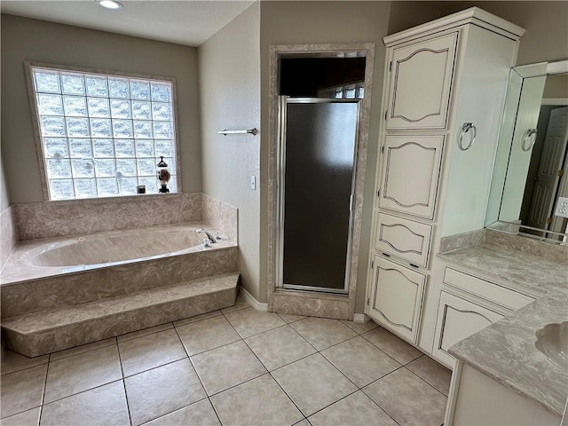 bathroom featuring tile patterned flooring, vanity, and plus walk in shower