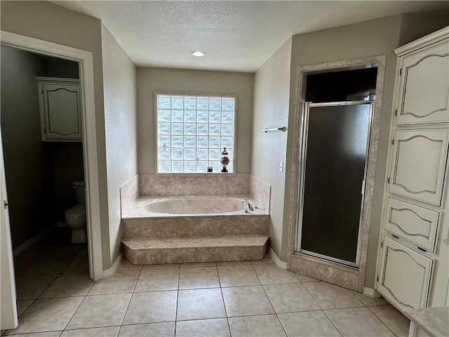 bathroom with tile patterned floors, toilet, a textured ceiling, and plus walk in shower