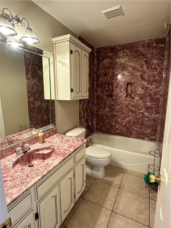 full bathroom featuring tiled shower / bath, vanity, toilet, and tile patterned flooring