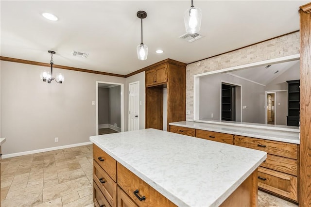 3658 Castle River Dr, Corpus Christi, TX 78410 - kitchen with brown cabinetry, light countertops, a center island, pendant lighting, and ornamental molding