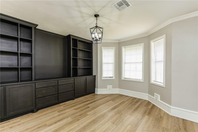 3658 Castle River Dr, Corpus Christi, TX 78410 - unfurnished dining area with a chandelier, light wood finished floors, and crown molding