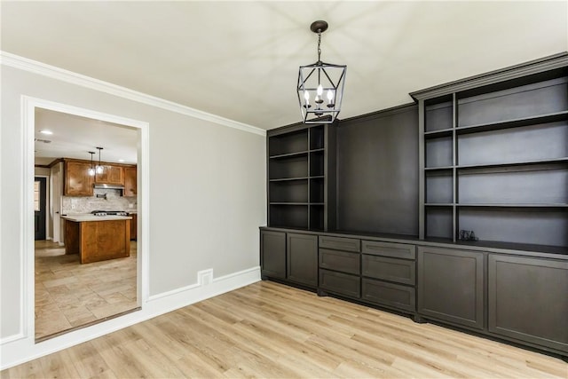 3658 Castle River Dr, Corpus Christi, TX 78410 - unfurnished dining area featuring a chandelier, ornamental molding, and light wood-style floors