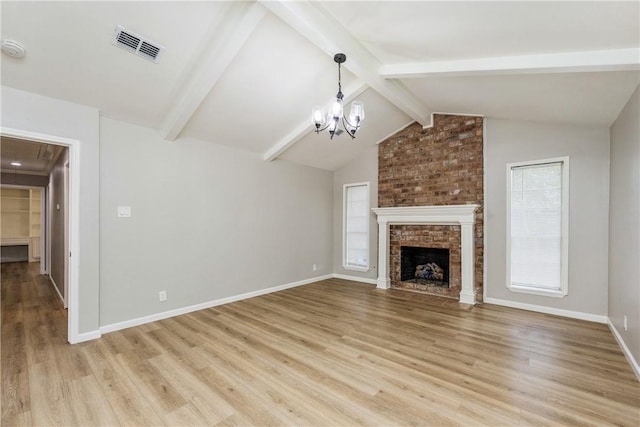 3658 Castle River Dr, Corpus Christi, TX 78410 - unfurnished living room with light wood-type flooring, a chandelier, a brick fireplace, and attic access