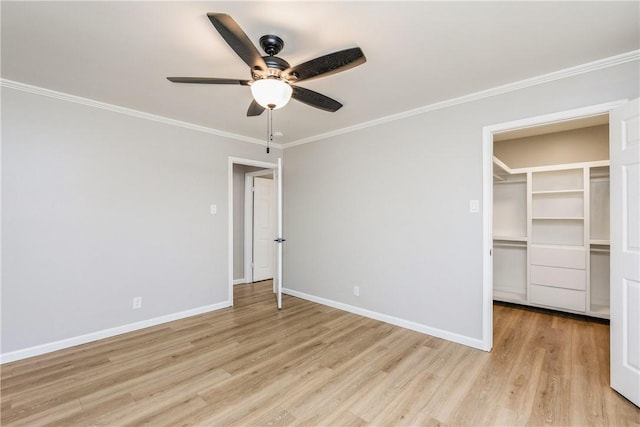 3658 Castle River Dr, Corpus Christi, TX 78410 - unfurnished bedroom featuring a walk in closet, light wood-style floors, ornamental molding, a closet, and ceiling fan