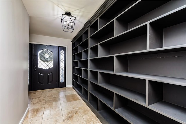 3658 Castle River Dr, Corpus Christi, TX 78410 - mudroom featuring a chandelier and stone finish floors
