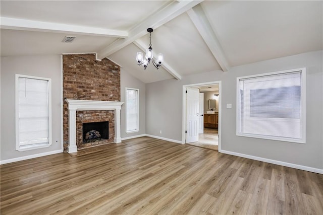 3658 Castle River Dr, Corpus Christi, TX 78410 - unfurnished living room featuring a chandelier, light wood finished floors, and a fireplace