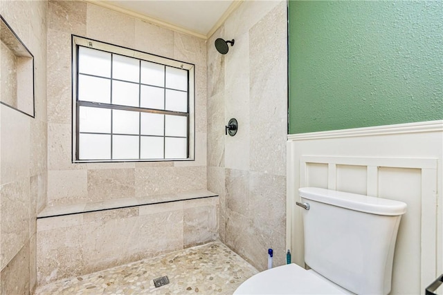 3658 Castle River Dr, Corpus Christi, TX 78410 - full bathroom featuring a wainscoted wall, a tile shower, ornamental molding, and a decorative wall