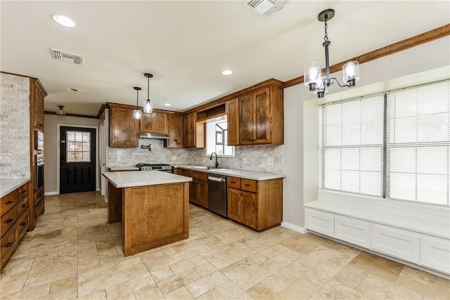 3658 Castle River Dr, Corpus Christi, TX 78410 - kitchen featuring stainless steel appliances, a chandelier, decorative backsplash, light countertops, and stone tile flooring