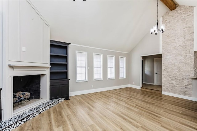 3658 Castle River Dr, Corpus Christi, TX 78410 - unfurnished living room with a fireplace, a chandelier, light wood-type flooring, beam ceiling, and high vaulted ceiling