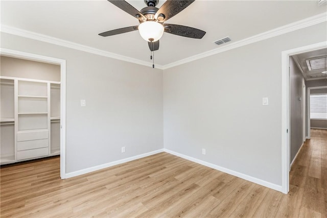 3658 Castle River Dr, Corpus Christi, TX 78410 - unfurnished bedroom featuring attic access, light wood-style flooring, ornamental molding, a spacious closet, and a ceiling fan