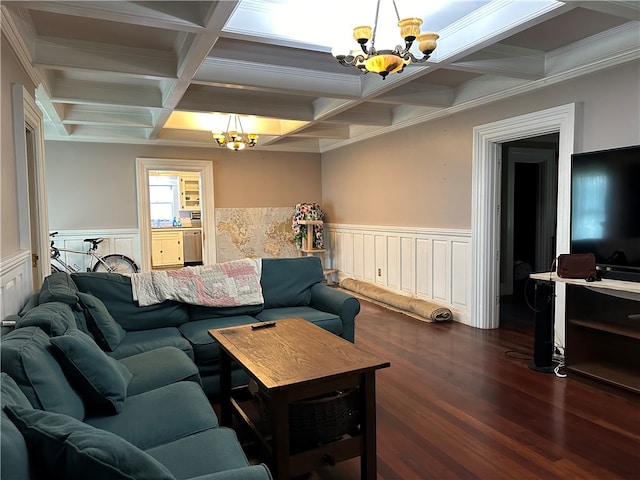 living room featuring beam ceiling, crown molding, coffered ceiling, and a chandelier