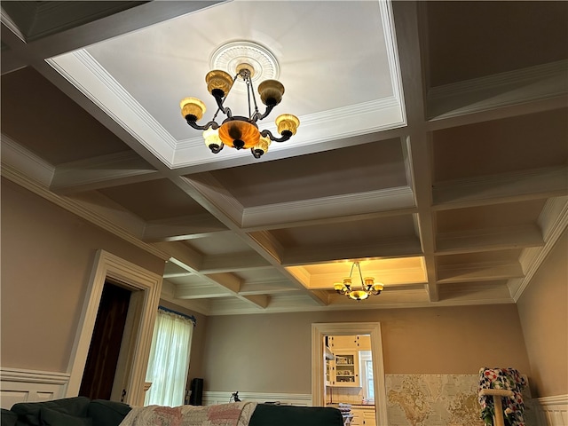 interior space with beamed ceiling, crown molding, coffered ceiling, and a notable chandelier