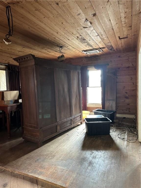 interior space featuring wood walls, wood ceiling, and hardwood / wood-style floors