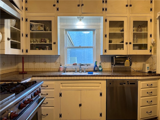 kitchen featuring white cabinets, dishwasher, sink, and stainless steel stove