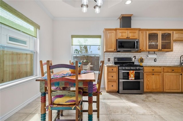 kitchen with decorative backsplash, light stone countertops, crown molding, and stainless steel appliances