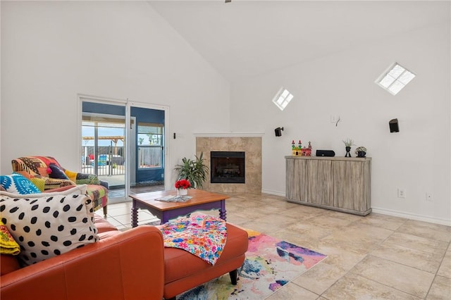 living room with high vaulted ceiling and a high end fireplace