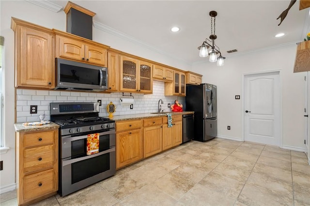 kitchen with appliances with stainless steel finishes, backsplash, light stone counters, and ornamental molding