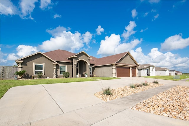 single story home featuring a garage and a front yard