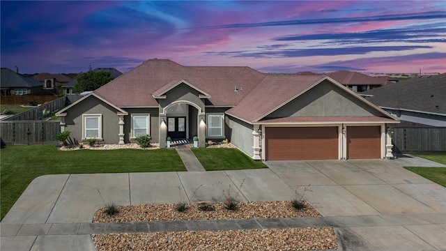 craftsman-style house with a garage and a yard