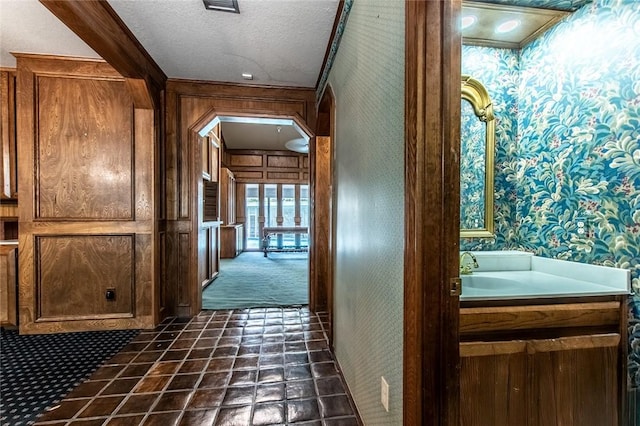 14733 Red River Dr, Corpus Christi, TX 78410 - hallway featuring a sink, a textured ceiling, and wallpapered walls