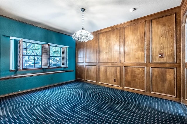 14733 Red River Dr, Corpus Christi, TX 78410 - empty room with dark carpet, baseboards, and a notable chandelier