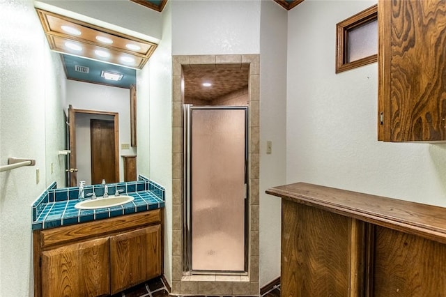 14733 Red River Dr, Corpus Christi, TX 78410 - bathroom with a textured wall, vanity, visible vents, and a stall shower