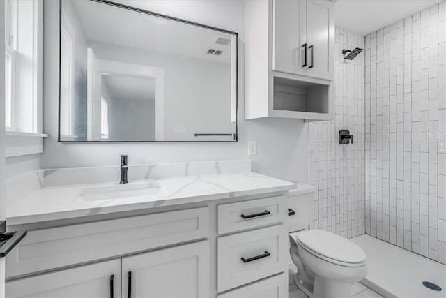 7025 Ashdown Dr, Corpus Christi, TX 78413 - bathroom with vanity, a tile shower, and toilet