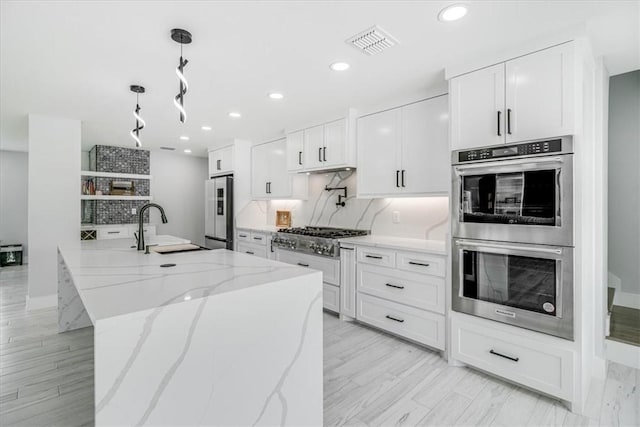7025 Ashdown Dr, Corpus Christi, TX 78413 - kitchen featuring appliances with stainless steel finishes, backsplash, white cabinets, a sink, and recessed lighting