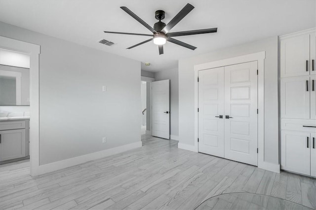 7025 Ashdown Dr, Corpus Christi, TX 78413 - unfurnished bedroom featuring light wood-style flooring, a closet, baseboards, ensuite bath, and a ceiling fan