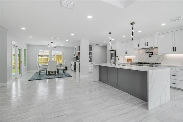 7025 Ashdown Dr, Corpus Christi, TX 78413 - kitchen with freestanding refrigerator, light countertops, recessed lighting, white cabinets, and a spacious island